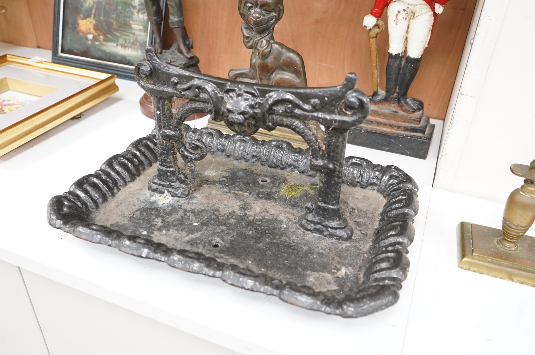 A collection of various metal wares to include door stops, boot scraper, spelter figure etc, largest 49cm high